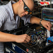 Man with safety glasses working on clock
